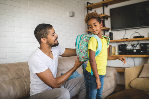 istock Father and a first grade child preparing for a school day 1074460926