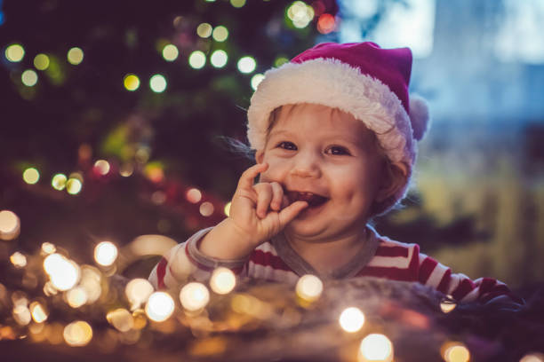 istock Cute boy indoors near Christmas tree 1074464106