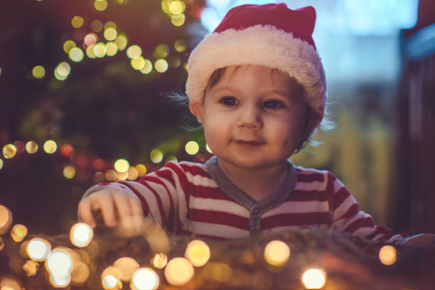 istock Cute boy indoors near Christmas tree 1074464198
