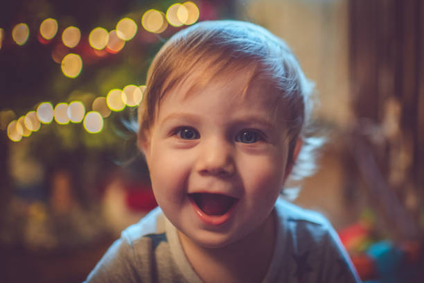 istock Cute boy near Christmas tree 1074464230