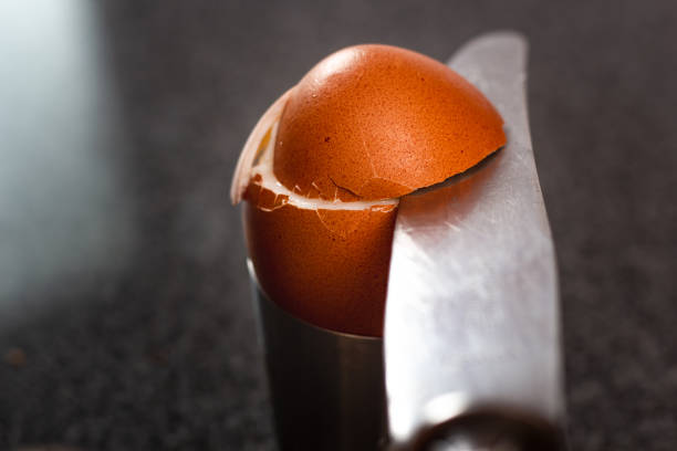 istock Cutting the top of a boiled egg with knife 1074482072