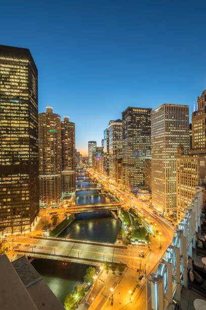 istock Illuminated waterfront skyscrapers along Chicago river at blue hour 1074490262