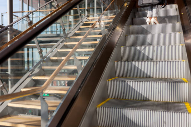 istock Woman ascends escalator 1074497378