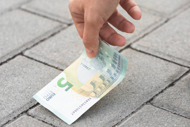 istock Woman is picking five euro banknote from the ground 1074499824