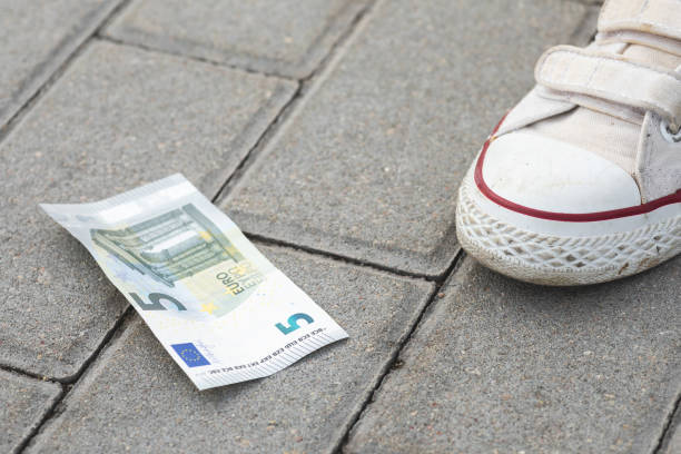 istock Female foot and five euro banknote 1074501794