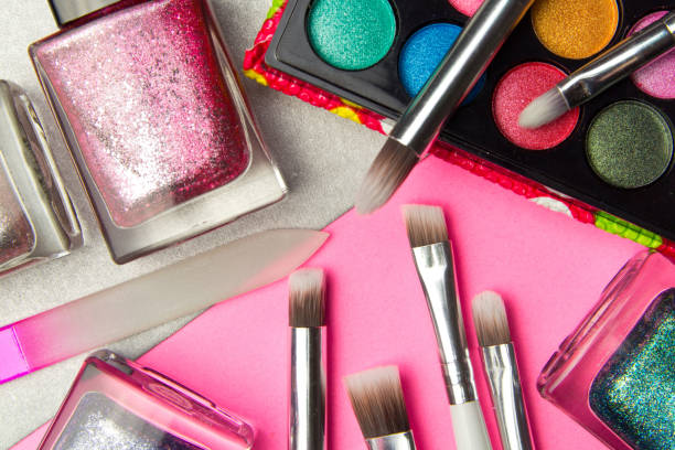 istock Eyeshadow palette and nail Polish in pink and silver geometric background. Decorative cosmetics for professional makeup. Eyeshadow and nail Polish colors trend. 1074503062