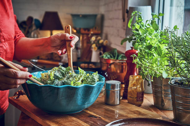 istock Preparing Cesar Salad with Chicken, Lettuce and Parmesan 1074506548
