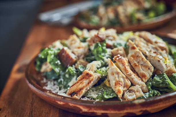 istock Preparing Cesar Salad with Chicken, Lettuce and Parmesan 1074506566