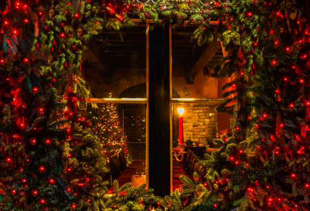 christmas tree and fireplace seen through a wooden cabin window - window snow christmas decoration imagens e fotografias de stock
