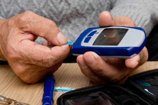 istock Concept diabetes in the elderly retired. Senior man with glucometer checking blood sugar level at home. Learn to use a glucometer 1074507224