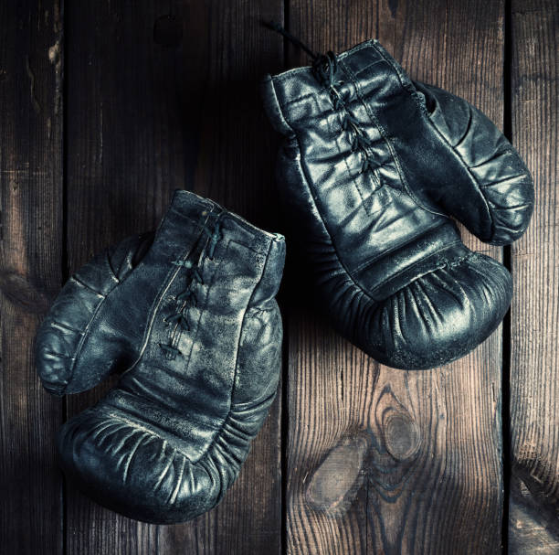 istock pair of black leather very old boxing gloves 1074509948