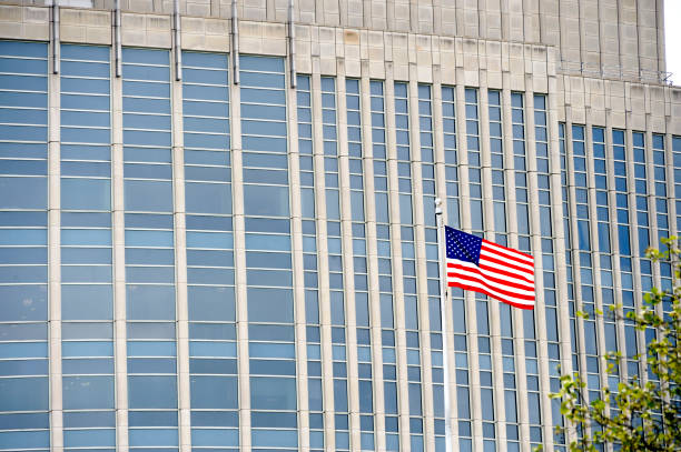 istock American flag in front of an office building 1074514520