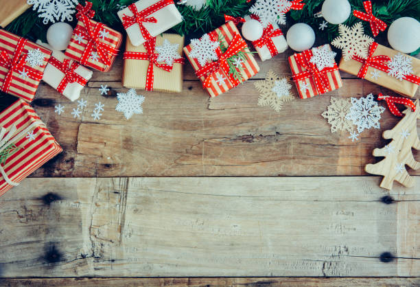 istock Christmas background with decorations and red gift boxes on the wooden board 1074515168