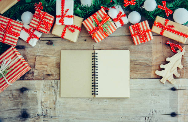 istock Christmas background with letter decorations and gift boxes on the wooden table. Top view. 1074515524