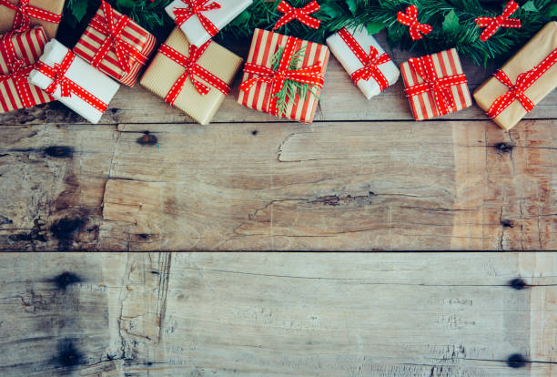 istock Christmas background with decorations and red gift boxes on the wooden board 1074515658