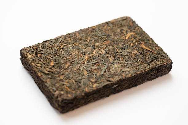 istock Puer raw tea. Pu-erh tea in brick shape. White background 1074520324