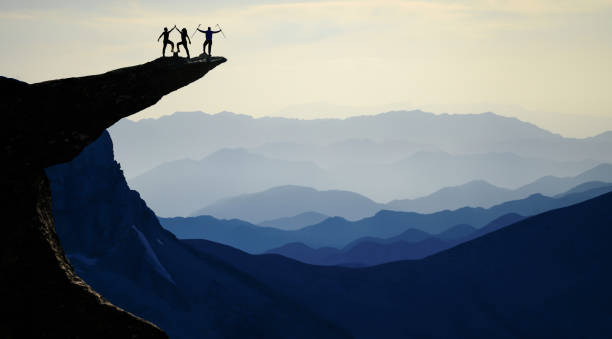 istock successful climbers on the summits of high mountains 1074524400
