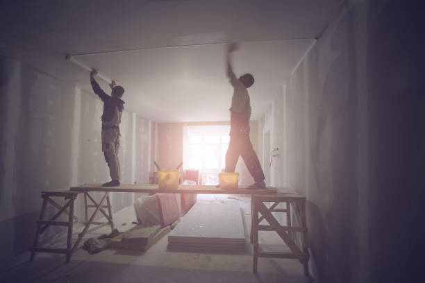 istock Workers are installing ceiling from wooden platform in apartment is under construction, remodeling, renovation, extension, restoration and reconstruction. 1074526666