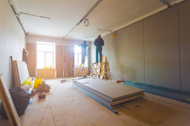 istock Working process of installing metal frames for plasterboard (drywall) for making gypsum walls with ladder and tools in apartment is under construction, remodeling, renovation, extension, restoration and reconstruction 1074526668