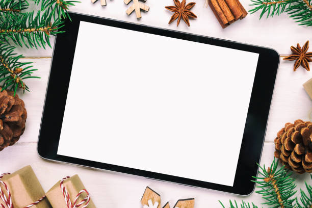 istock Digital tablet mock up with rustic Christmas wooden background decorations for app presentation. top view vintage, toned with copy space 1074529692
