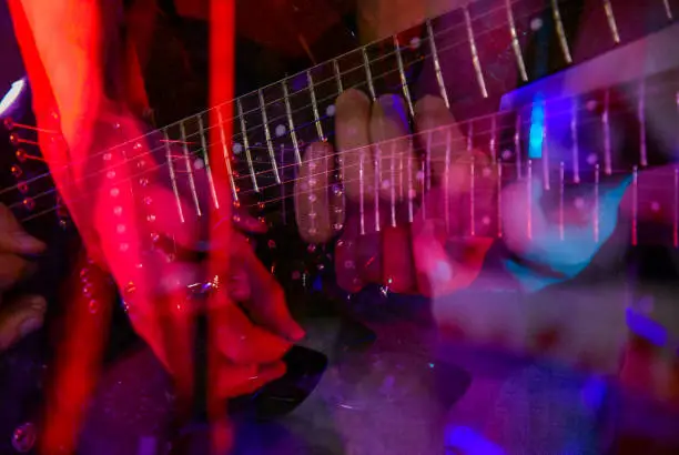 Photo of The neck of the guitar hand guitar player during the game
