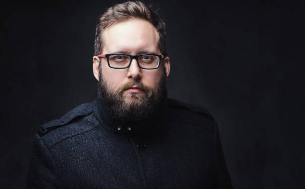 istock Serious plump male in eyeglasses over grey background. 1074535280