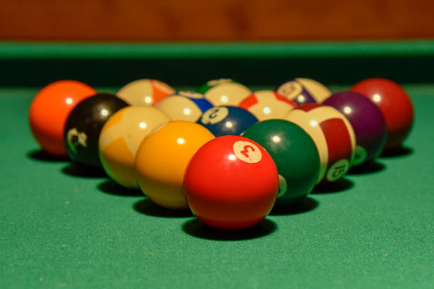 istock Billiard balls and cue on the pool table 1074535322