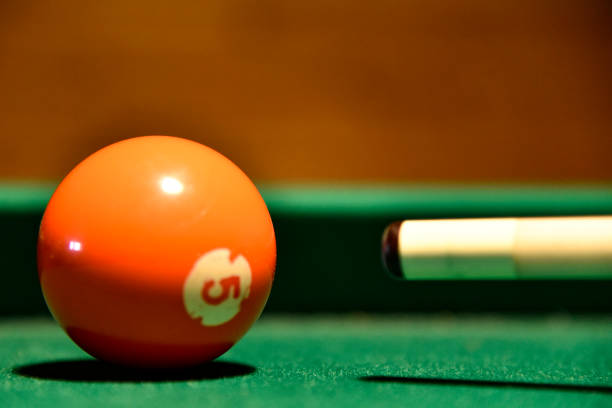 istock Billiard balls and cue on the pool table 1074535326