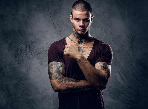 istock Tattooed male with crossed arms over grey background. 1074544468