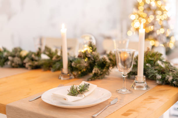 istock Christmas table setting. Beautiful served table with decorations, candles and lanterns. Living room decorated with lights and Christmas tree. 1074549752