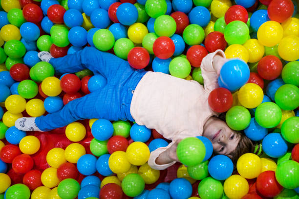 istock Cute Little boy playing at colorful plastic balls playground. 1074576772