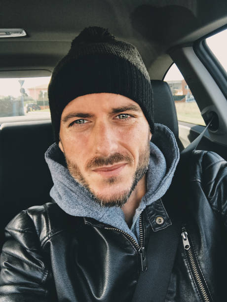 nice man with hat vehicle interior portrait in winter