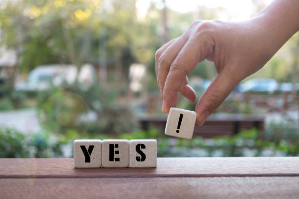 istock YES!  Concept with Hand and alphabet blocks 1074624710