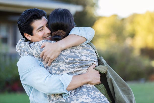 istock Male and female in uniform share a long awaited hug 1074625234
