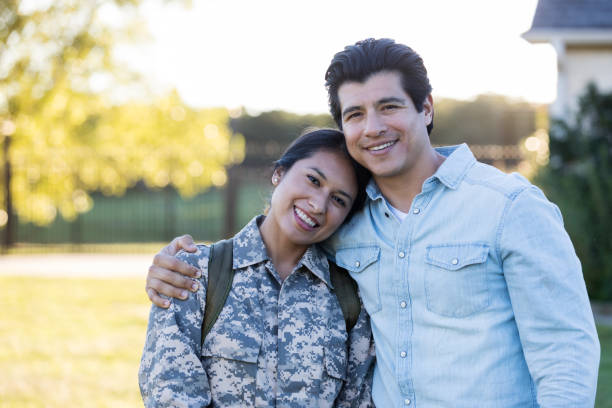 istock Young female in uniform poses for a picture with husband 1074625266