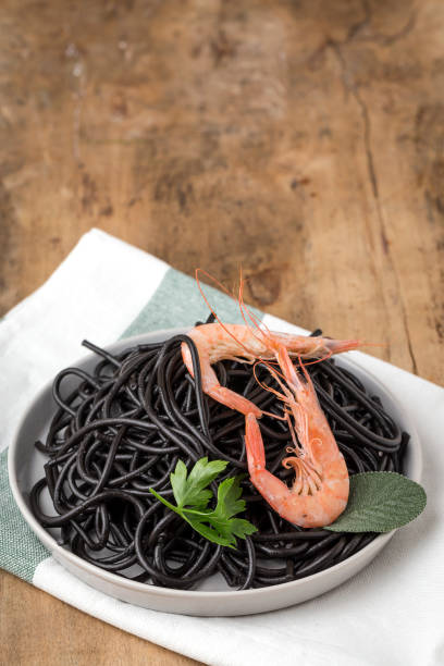 istock Black spaghetti with prawns. Homemade. 1074630494