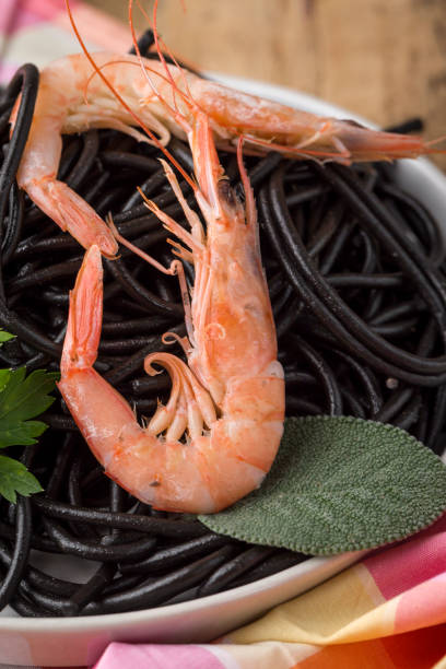 istock Black spaghetti with prawns. Homemade. 1074630496