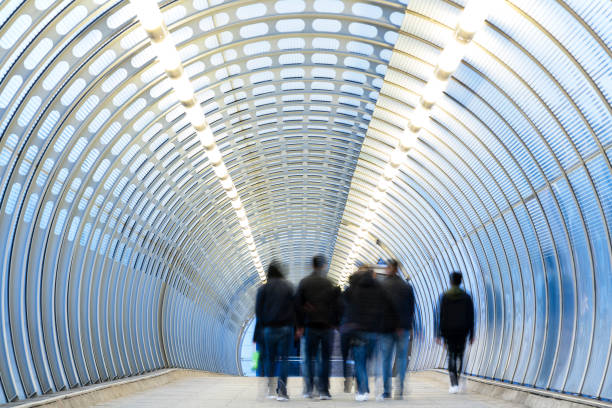 istock Blurred Commuters Rushing Down Modern Tunnel in London 1074632228