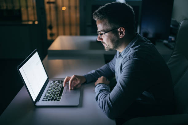 istock Businessman using laptop and sitting in the office late at night. 1074636766