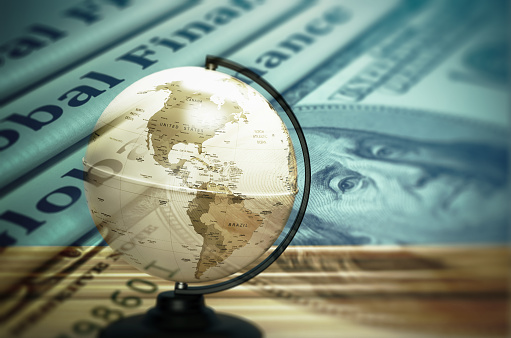 Global finance concept. Globe sphere, dollar, and global finance text compositing holographic image. Global finance, and the global economy concept for the finance and business industry.