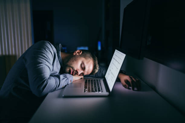 young caucasian businessman sleeping in the office late at night. next to him laptop. - garment emotional stress equipment household equipment imagens e fotografias de stock