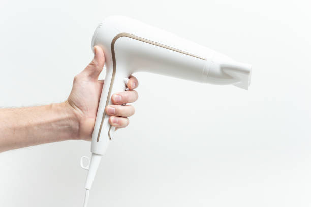 istock The human hand is holding a hair dryer. 1074643258