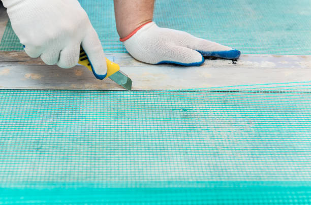 istock A worker is cutting  a fiberglass mesh. 1074643864