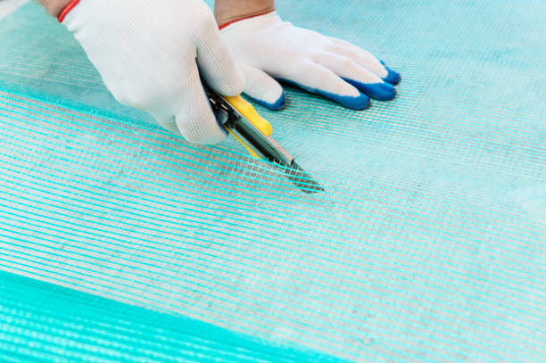 istock A worker is cutting  a fiberglass mesh. 1074643888