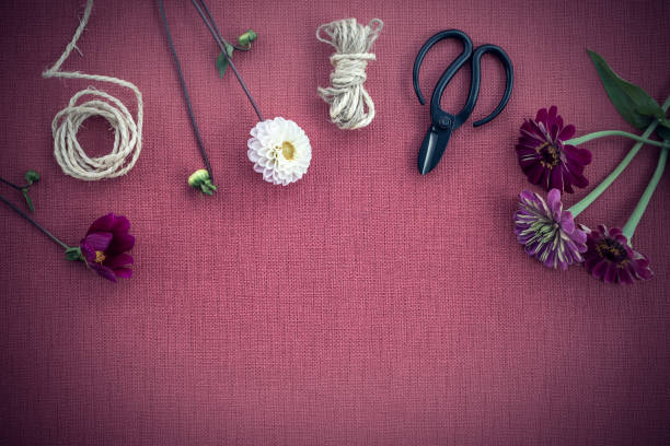 istock Florist workspace on dark purple canvas background 1074647332