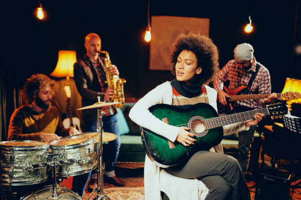 istock Mixed race woman playing acoustic guitar. 1074647674
