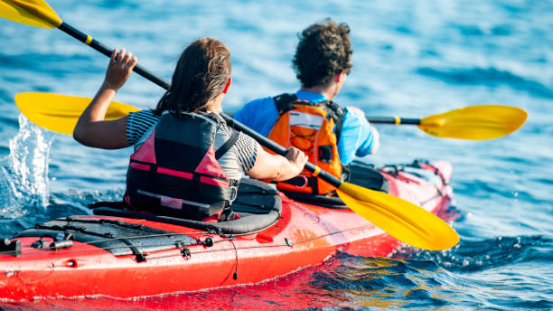 istock Couple on a kayak rowing at sea 1074651266
