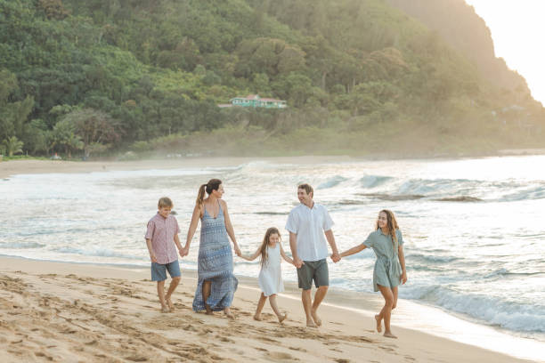 istock Family walking together on the beach 1074653464