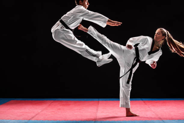 istock Man and woman taekwondo combat 1074659200