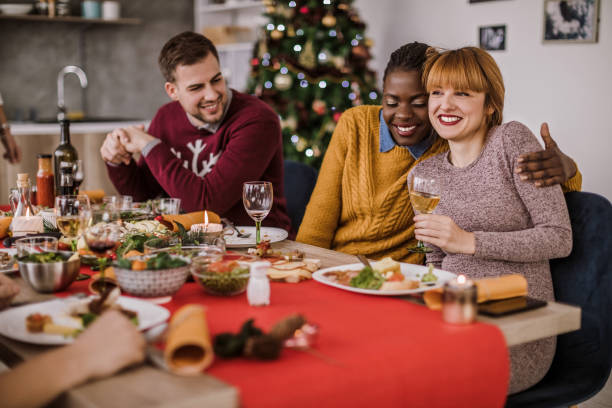 istock Happy Young Women Embracing Affectionately On Christmas Eve 1074669558